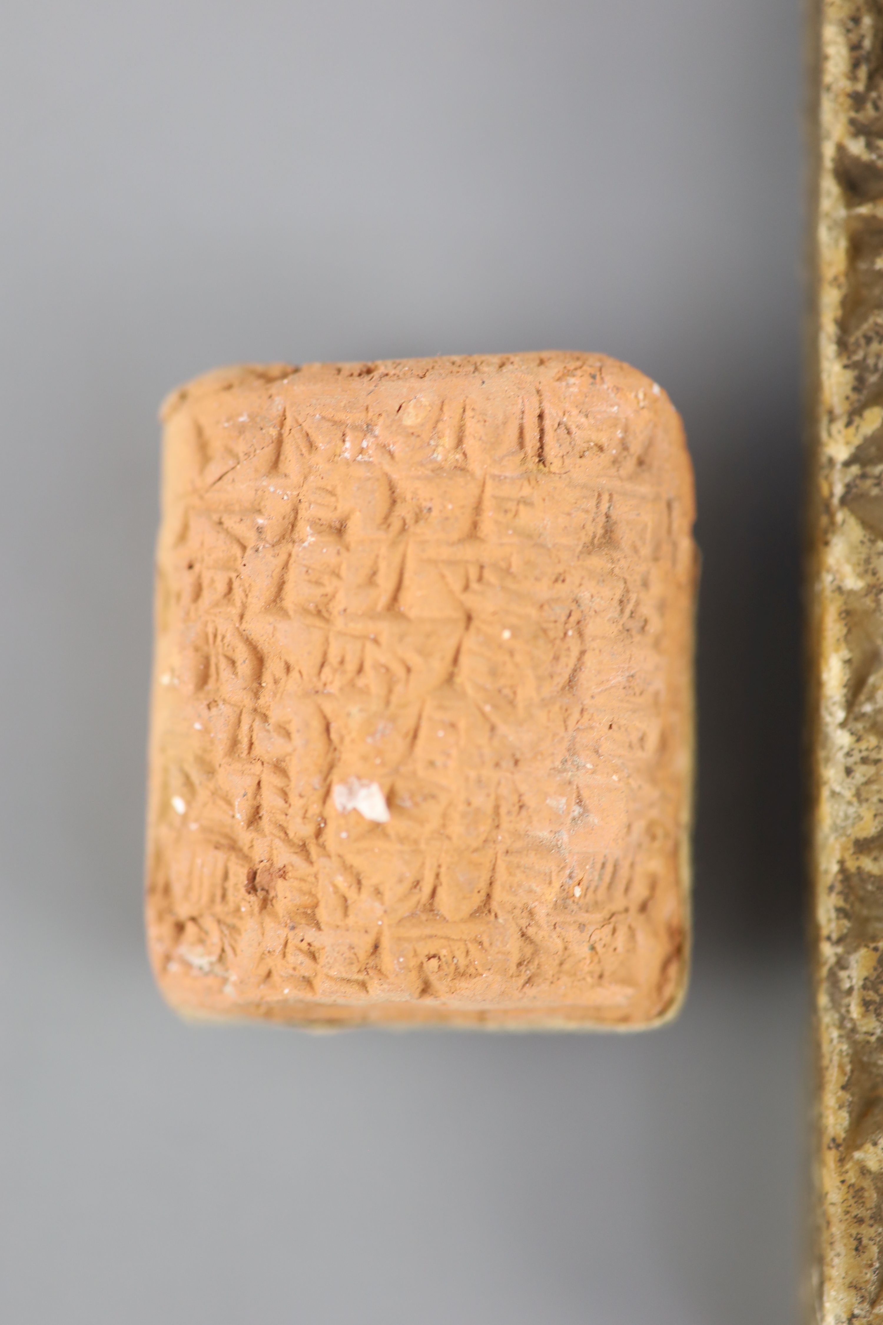 An Ancient Assyrian fragment of a cuneiform alabaster slab, probably 9th century BC from Kouyunjik (Nineveh) and two clay cuneiform tab
